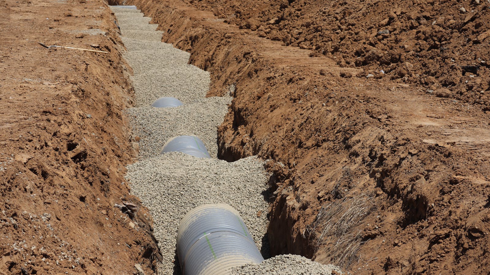 Drainage pipe bedded in stone in a trench